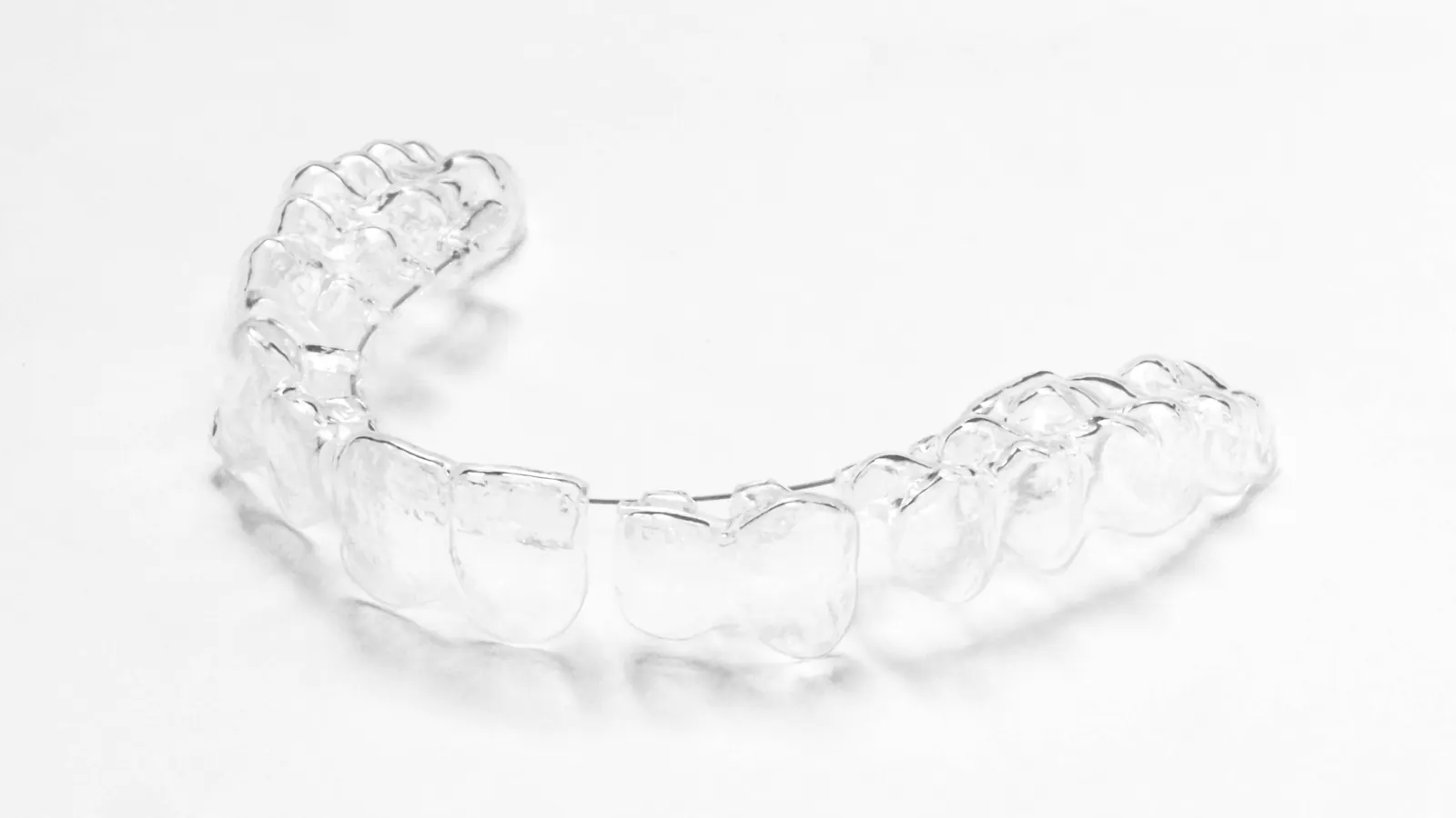 A clear aligner on a plain white background