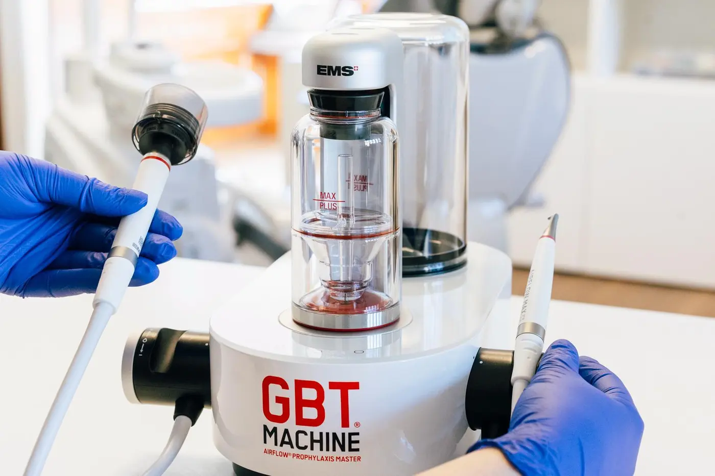 The EMS AirFlow and Piezon handpieces being lifted from the GBT machine